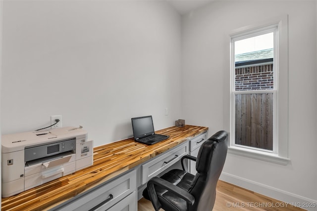 office area with baseboards and light wood-style flooring