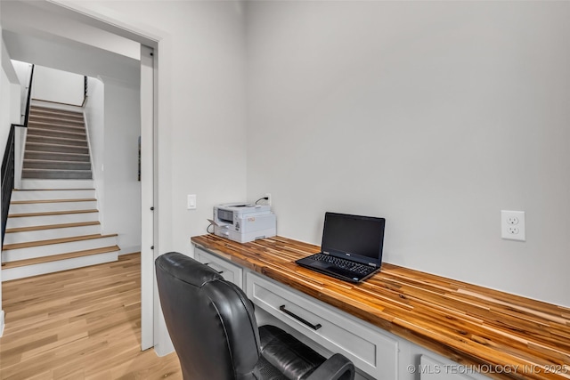 office featuring built in desk and light wood-style flooring