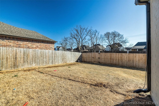 view of yard with a fenced backyard