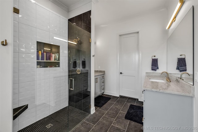 full bathroom featuring a stall shower, vanity, and baseboards