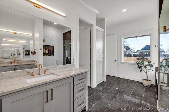 bathroom featuring recessed lighting, baseboards, a shower stall, and vanity