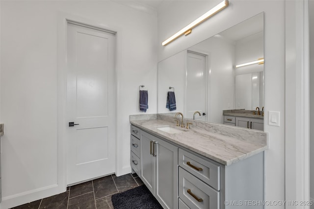 bathroom featuring baseboards and vanity