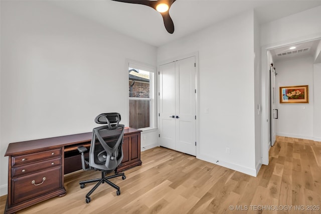 office with visible vents, baseboards, and light wood-style flooring