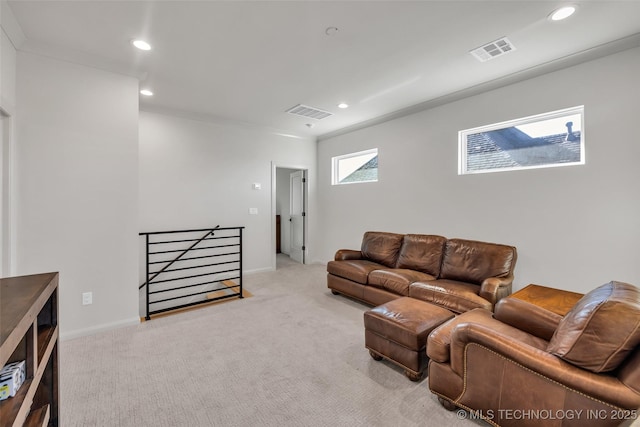 carpeted living room featuring visible vents, recessed lighting, baseboards, and ornamental molding