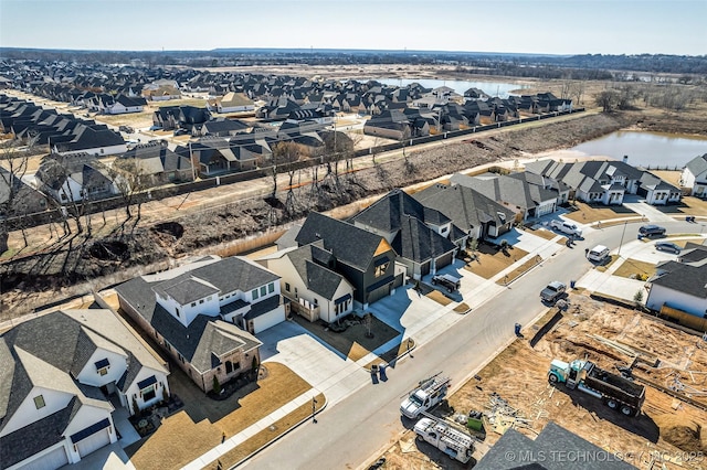 bird's eye view with a residential view and a water view