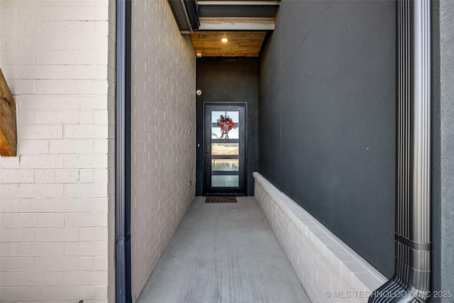 doorway to property with brick siding