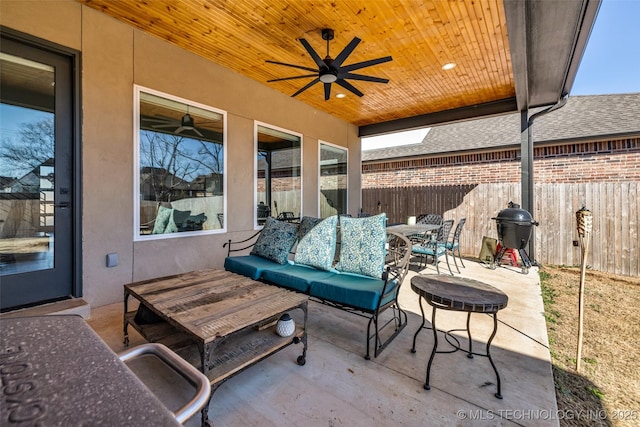 view of patio featuring area for grilling, outdoor dining space, a ceiling fan, and fence