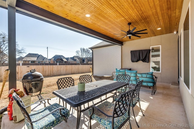 view of patio / terrace with outdoor dining space, fence, and ceiling fan