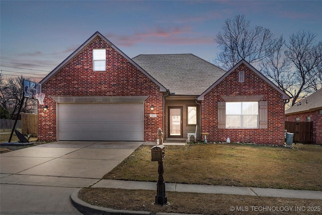 traditional home featuring brick siding, concrete driveway, a garage, and fence