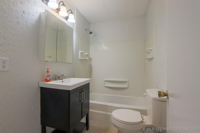 bathroom with vanity, toilet, a textured wall, and shower / bathtub combination