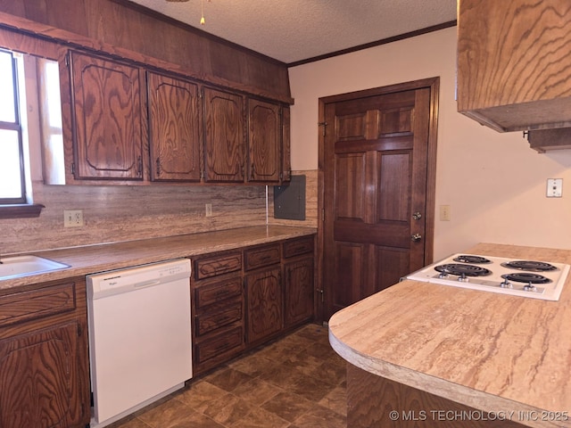 kitchen featuring electric panel, a sink, a textured ceiling, white appliances, and crown molding