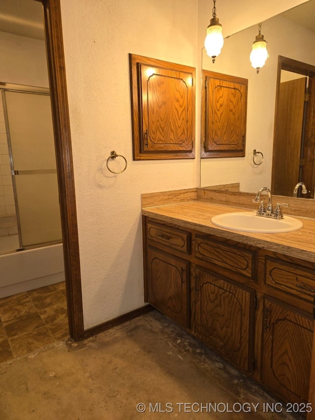 full bathroom with vanity, baseboards, and bath / shower combo with glass door