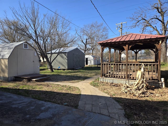 view of yard with a gazebo, a storage shed, and an outbuilding