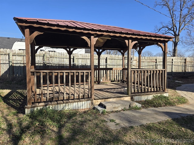 view of home's community with a gazebo, a wooden deck, and fence