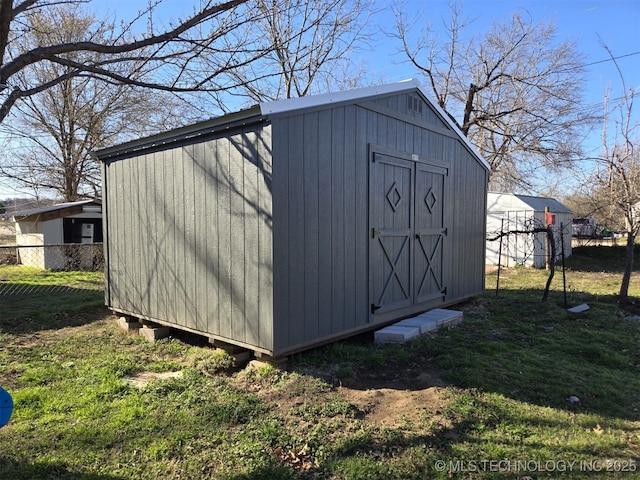 view of shed with fence