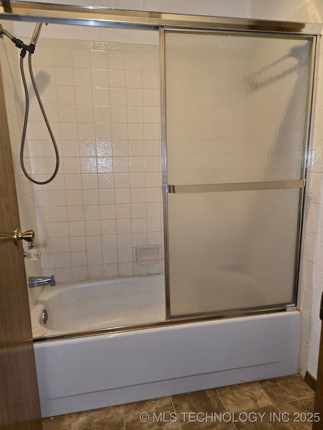 full bath featuring shower / bath combination with glass door