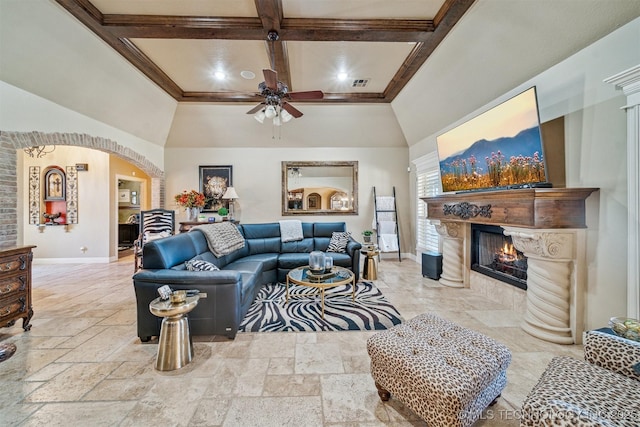 living area with visible vents, baseboards, a tile fireplace, arched walkways, and coffered ceiling