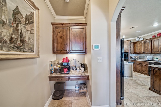 7161 Hackberry Rdg, Owasso, OK 74055 - bar with ornamental molding, baseboards, tasteful backsplash, and light stone finish flooring