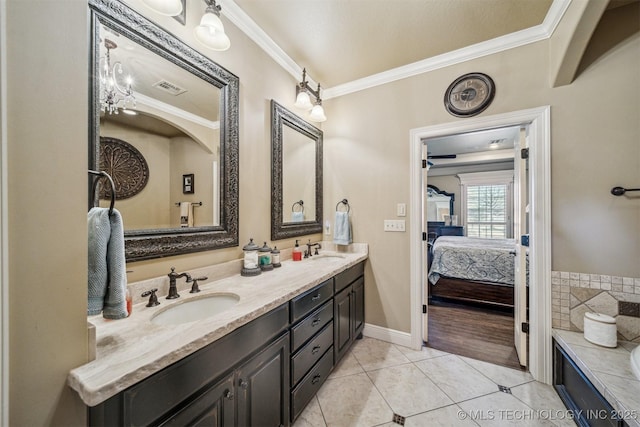 full bathroom featuring tile patterned floors, double vanity, crown molding, and a sink