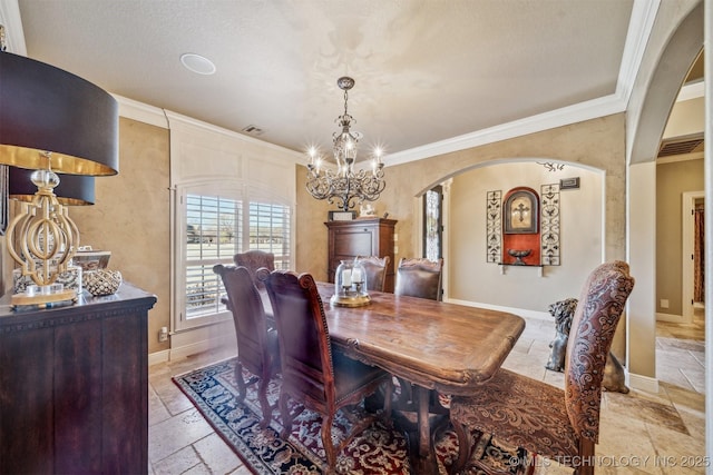 dining area featuring visible vents, baseboards, ornamental molding, stone tile floors, and a notable chandelier