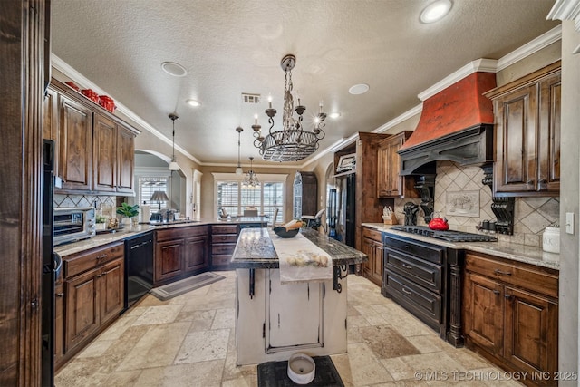 kitchen with visible vents, gas cooktop, stone tile floors, arched walkways, and dishwasher