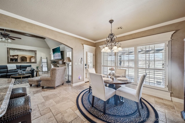 dining space featuring stone tile flooring, visible vents, arched walkways, and baseboards