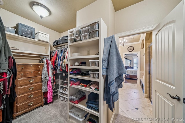 spacious closet featuring tile patterned floors and carpet flooring