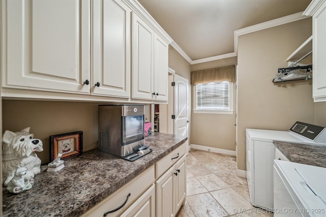 clothes washing area with washing machine and dryer, cabinet space, baseboards, and ornamental molding