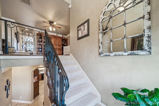 staircase with visible vents and a ceiling fan