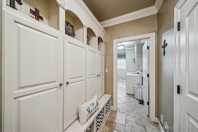 mudroom featuring washer / dryer, stone tile flooring, and ornamental molding