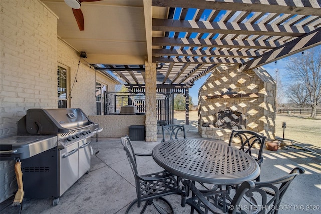 view of patio / terrace featuring a grill, outdoor dining space, a fireplace, and a pergola