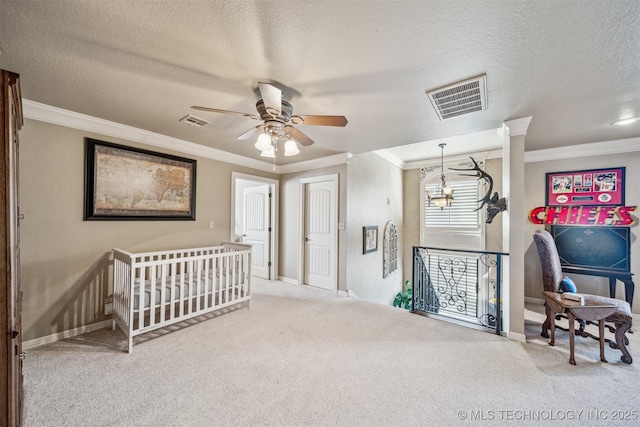 hallway with visible vents, an upstairs landing, carpet floors, and crown molding