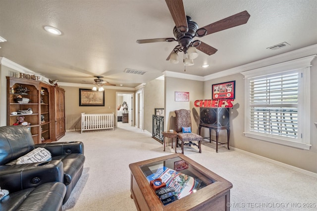 carpeted living room featuring visible vents, a textured ceiling, baseboards, and ornamental molding