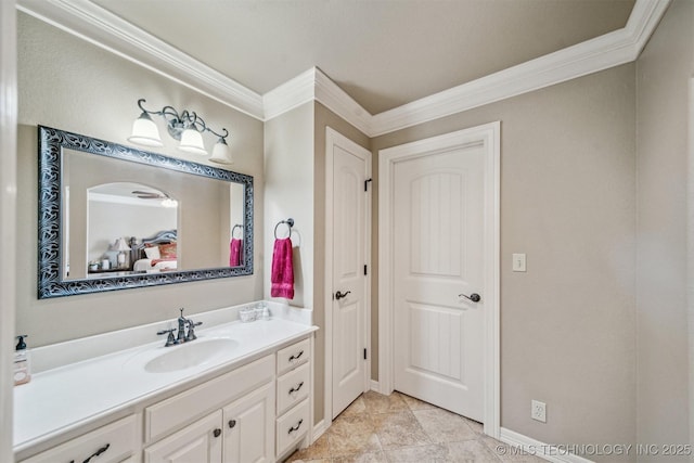 bathroom featuring baseboards, vanity, and crown molding