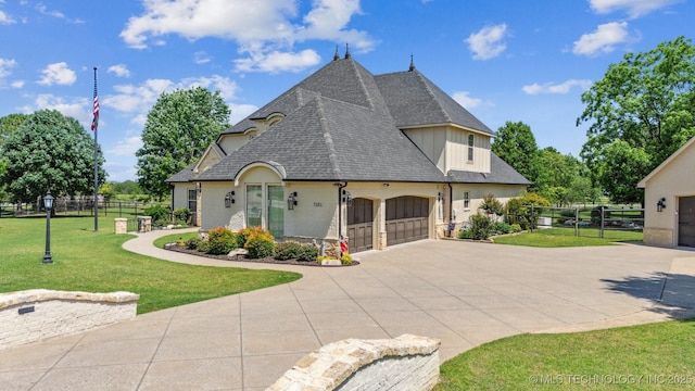 7161 Hackberry Rdg, Owasso, OK 74055 - view of front of house featuring driveway, a garage, and a shingled roof