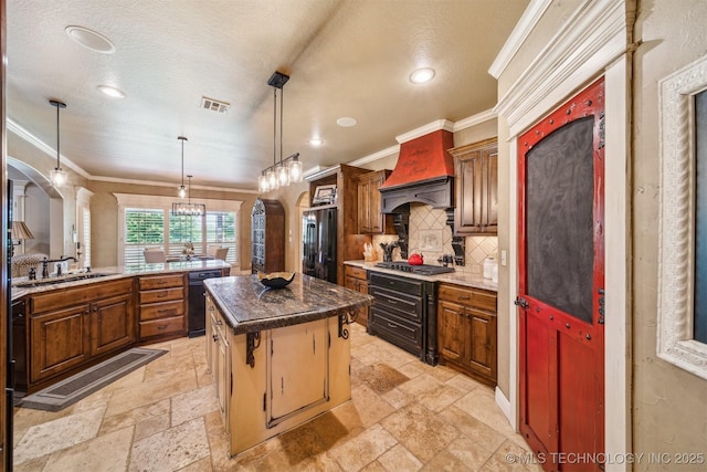 7161 Hackberry Rdg, Owasso, OK 74055 - kitchen featuring refrigerator, premium range hood, stone tile flooring, stainless steel gas cooktop, and ornamental molding