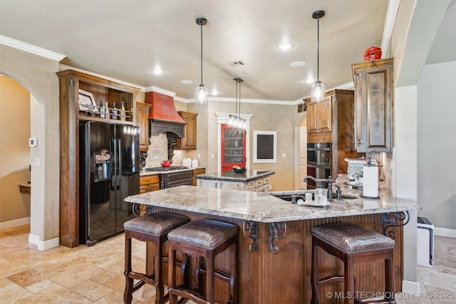 7161 Hackberry Rdg, Owasso, OK 74055 - kitchen featuring black appliances, a kitchen island, arched walkways, a peninsula, and baseboards