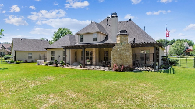 7161 Hackberry Rdg, Owasso, OK 74055 - back of house with a chimney, a patio, roof with shingles, and stone siding