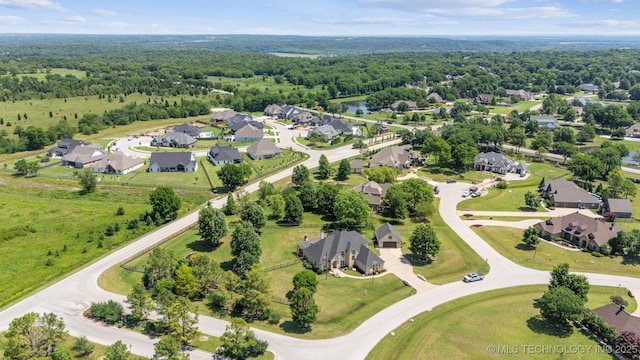 7161 Hackberry Rdg, Owasso, OK 74055 - aerial view of residential area with a heavily wooded area