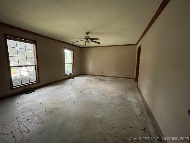 spare room featuring crown molding, visible vents, baseboards, and concrete floors