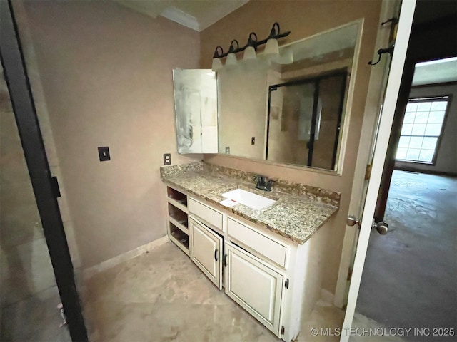 bathroom featuring baseboards and vanity