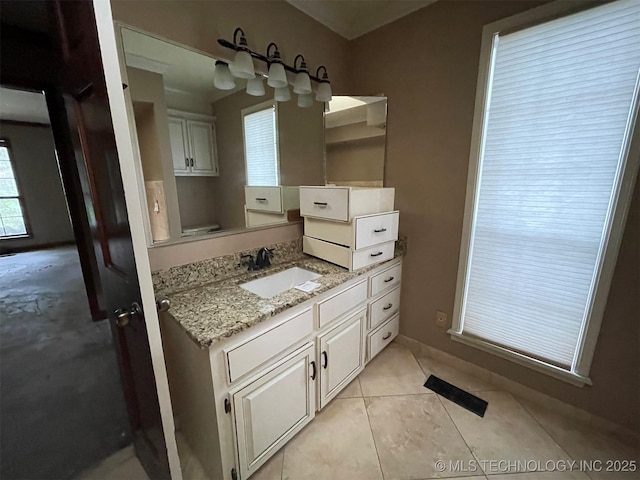 bathroom featuring baseboards, vanity, and tile patterned flooring