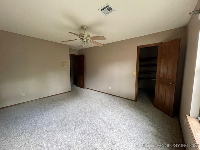 empty room featuring light carpet, baseboards, visible vents, and ceiling fan