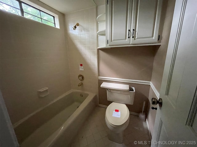 full bath featuring toilet, baseboards, and shower / bathtub combination