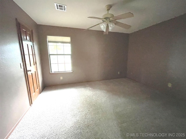 spare room with visible vents and ceiling fan