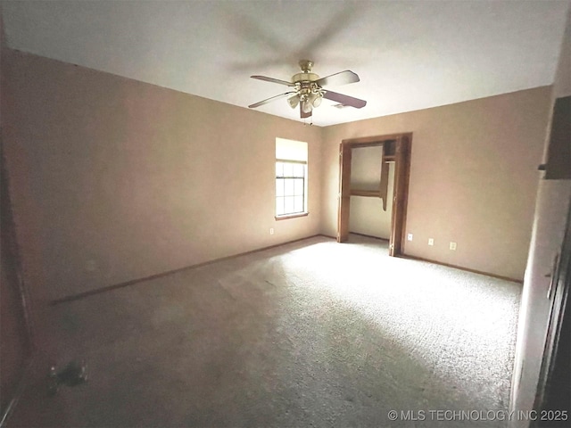 empty room with baseboards and ceiling fan