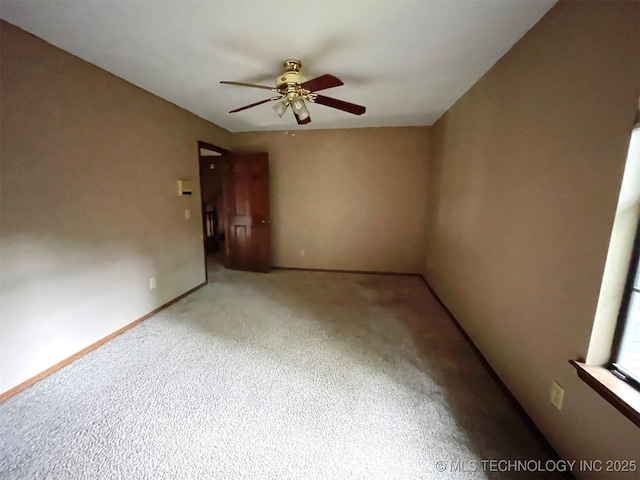 unfurnished room featuring carpet flooring, baseboards, and ceiling fan