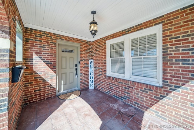 property entrance featuring brick siding