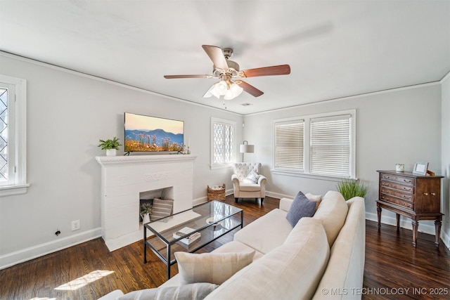 living area with a fireplace with flush hearth, baseboards, and wood finished floors