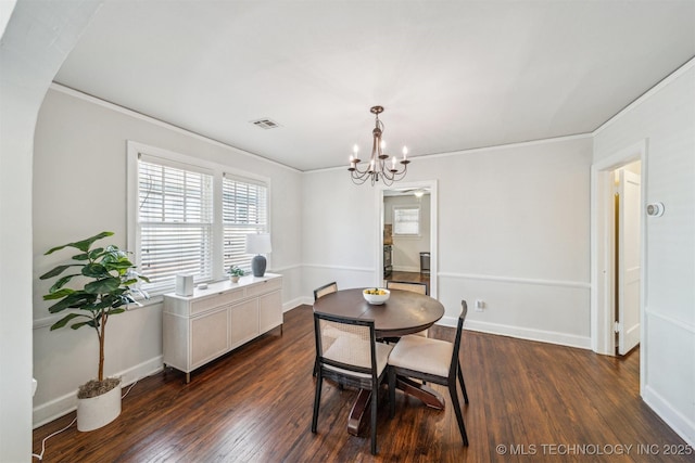 dining area with visible vents, a notable chandelier, dark wood finished floors, crown molding, and baseboards